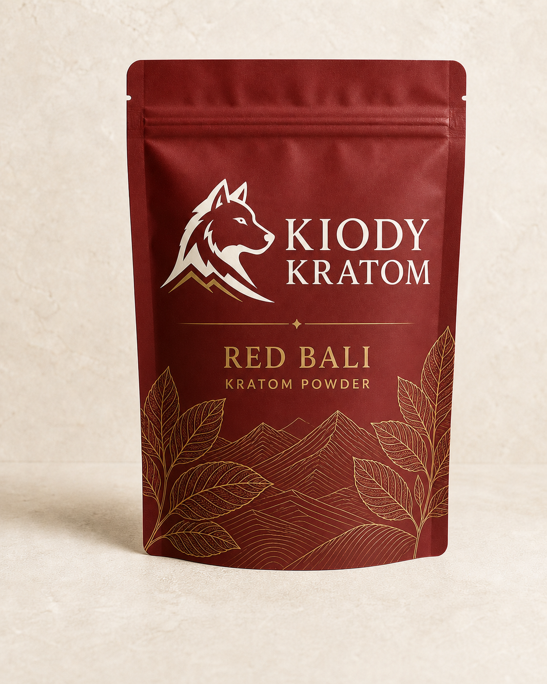 Kiody Red Bali kratom powder in a clay red 100 gram pouch with gold kratom leaves and mountain lines