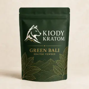 Kiody Green Bali Kratom powder in a forest-green pouch with gold botanical artwork