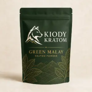 Kiody Green Malay Kratom powder in a forest-green pouch with gold botanical artwork