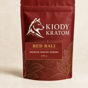 Kiody Premium Red Bali Kratom Powder 100 g bag with current wolf logo and antique-gold botanical inlay
