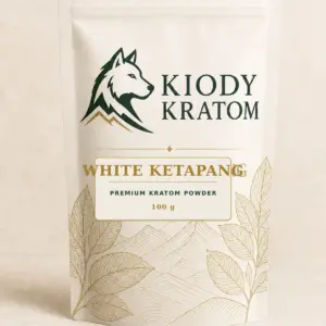 Kiody Premium White Ketapang Kratom Powder 100 g bag with current wolf logo and antique-gold botanical inlay