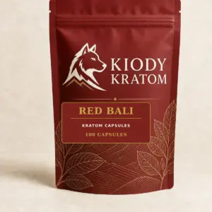 Kiody Red Bali Kratom Capsules 100-count bag with current wolf logo and antique-gold botanical inlay