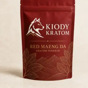 Kiody Red Maeng Da Kratom powder in a clay-red pouch with gold botanical artwork