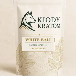 Kiody White Bali Kratom Capsules 100-count bag with current wolf logo and antique-gold botanical inlay