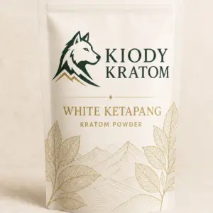 Kiody White Ketapang Kratom powder in a warm-ivory pouch with gold botanical artwork