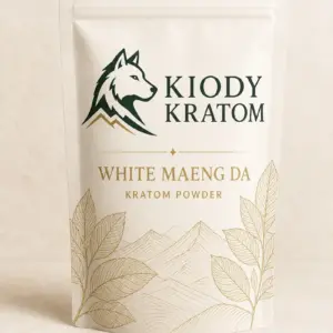 Kiody White Maeng Da Kratom powder in a warm-ivory pouch with gold botanical artwork