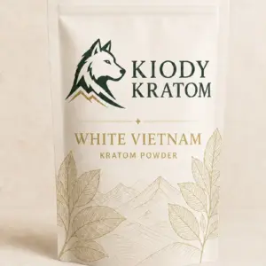 Kiody White Vietnam Kratom powder in a warm-ivory pouch with gold botanical artwork