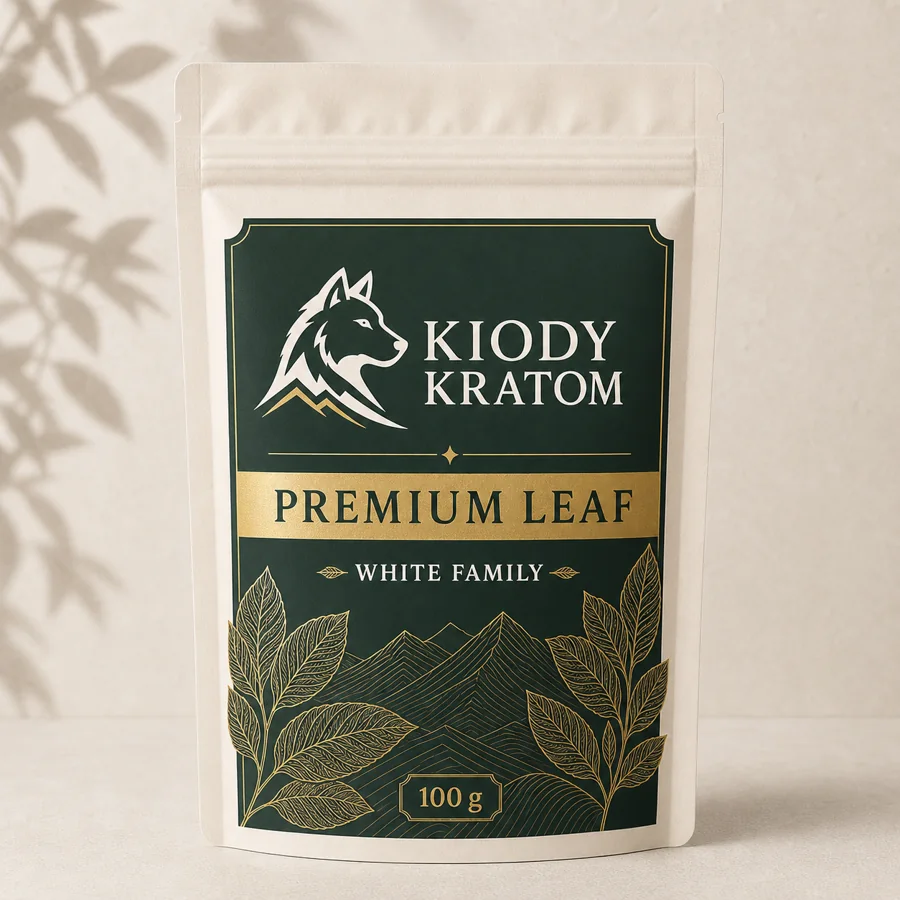Kiody White Family Premium Leaf kratom powder in a warm ivory 100 gram pouch with gold wolf, leaves, and mountain lines