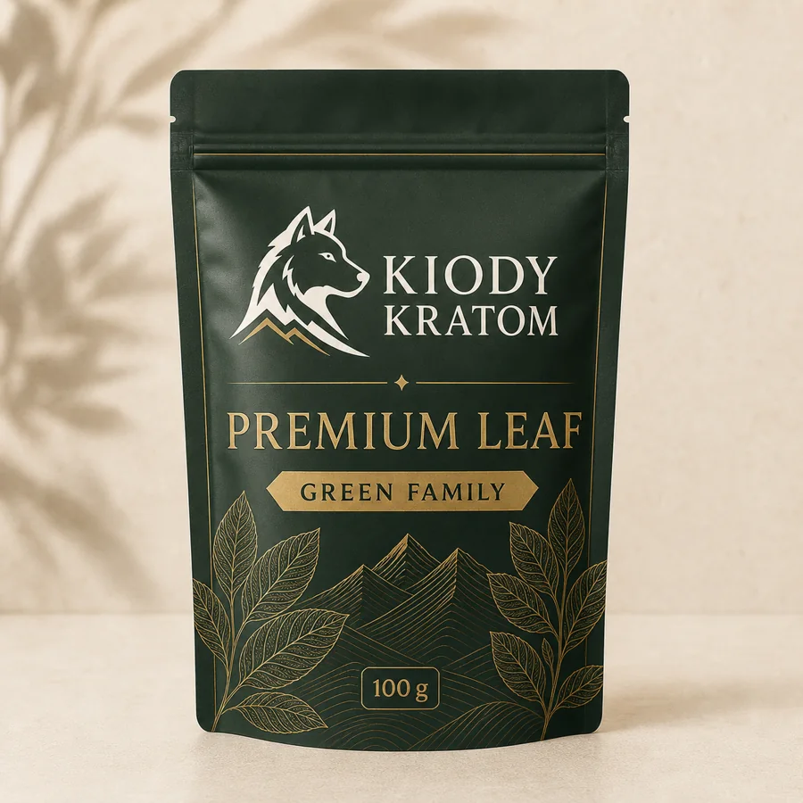 Kiody Green Family Premium Leaf kratom powder in a deep forest 100 gram pouch with gold wolf, leaves, and mountain lines